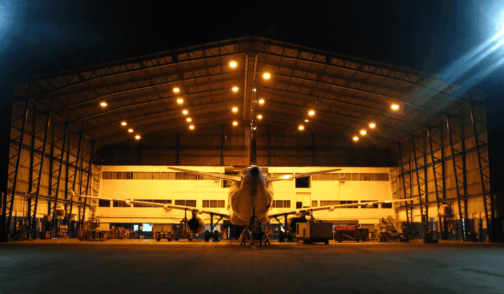 Aircraft hangar with a large-span steel truss roof spanning a column-free bay