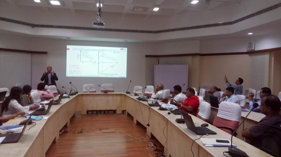 Corporate PLAXIS workshop in a boardroom with stress-path plots on screen