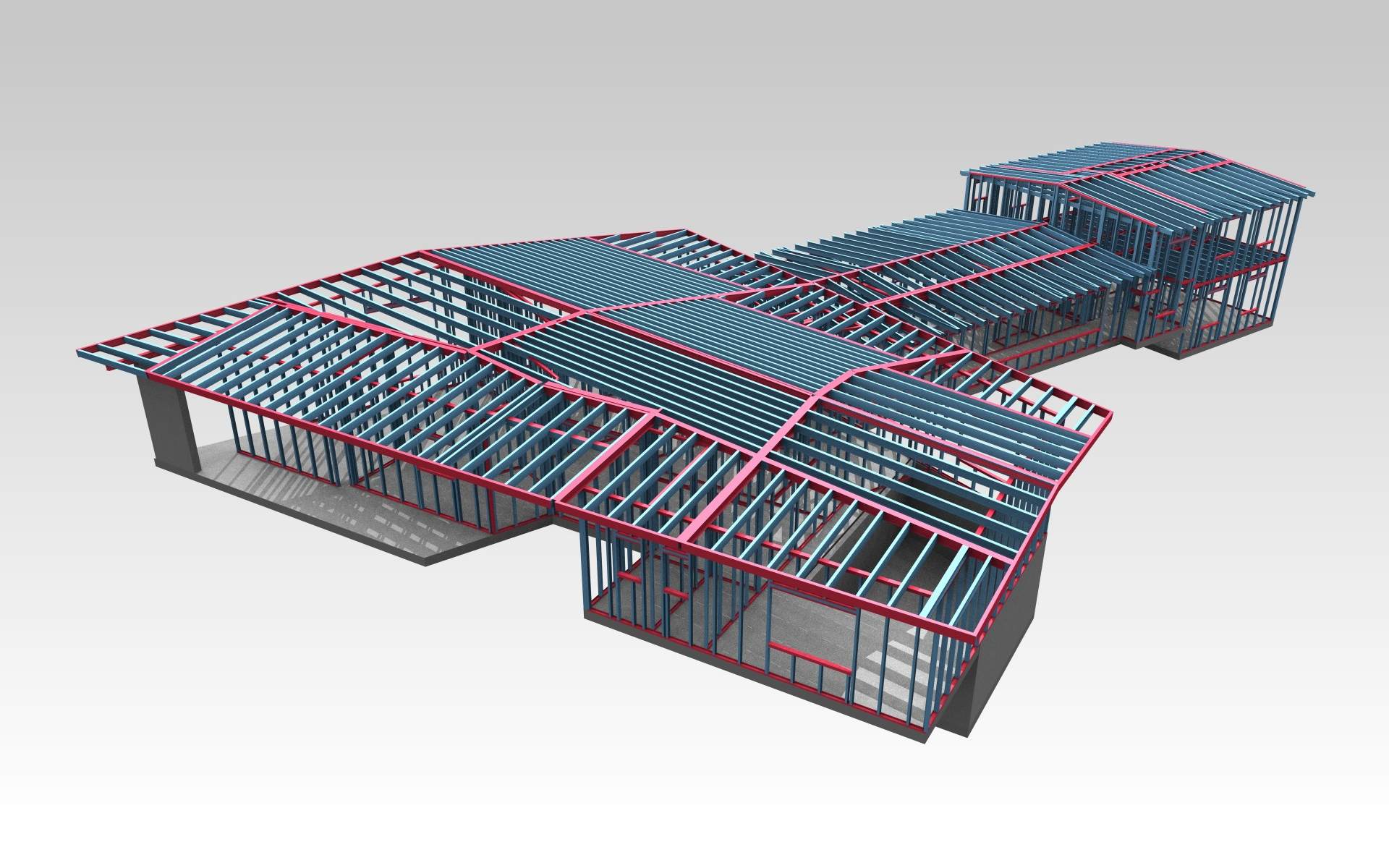 A single-storey building framed end to end in light-gauge steel — wall studs, roof rafters and top and bottom tracks standing on a stepped concrete slab, shown as a bare frame with no cladding